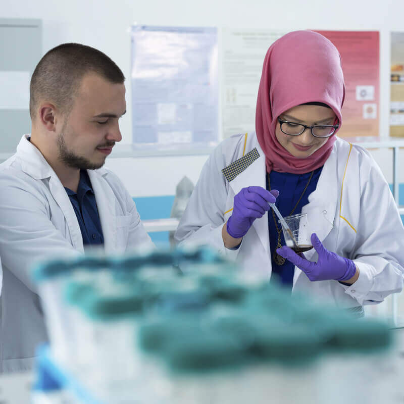 Image: lab techs working in lab